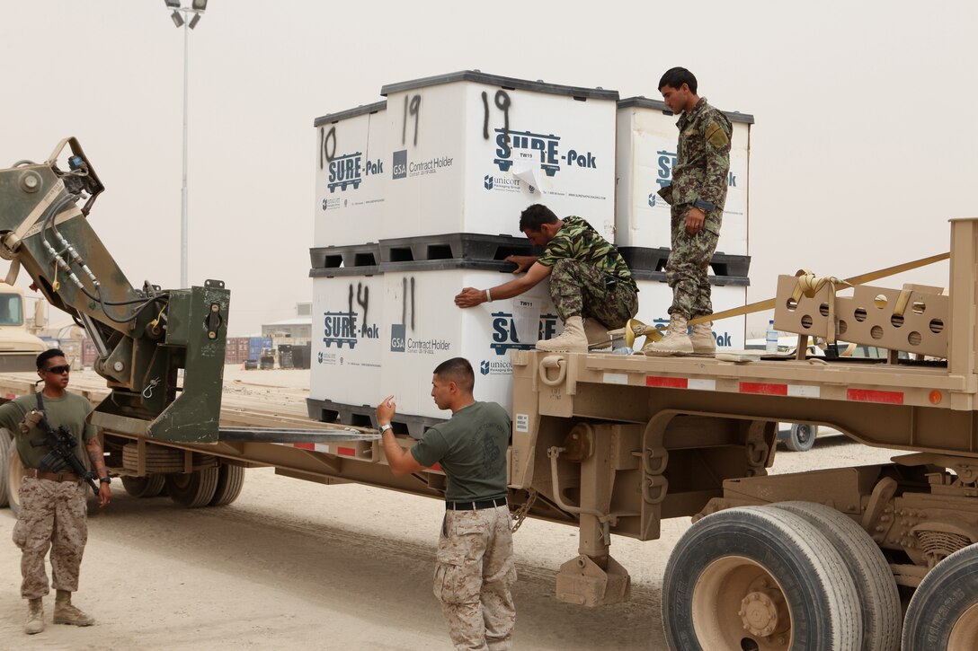 Marines with Marine Air-Ground Task Force Material Distribution Center, Supply Company, 1st Maintenance Battalion (-) (Reinforced) and Afghan soldiers with Regional Logistics Command-Southwest load crates of excess consumable medical supplies onto an Afghan National Army truck at Camp Leatherneck, Afghanistan, May 24. Once delivered to RLSC-SW, the Forward Supply Depot Element will distribute the supplies to the Afghan National Army’s 215th Corps.