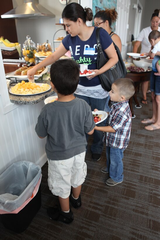 Lincoln Military Housing residents make their way through the buffet line during the Military Spouse Appreciation Day event held at the Heroes Manor District Club House May 15 aboard Marine Corps Base Camp Lejeune. 