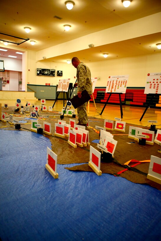 Maj. Sean P. Dynan, the Operational Planning Team Leader for the Marine Expeditionary Force Exercise, explains the orientation of a map used during MEFEX 12, aboard Marine Corps Base Camp Lejeune, N.C., May 20, 2012. The MEFEX is a large scale exercise for conventional combat operations. (U.S. Marine Corps photo by Cpl. Daniel A. Wulz)