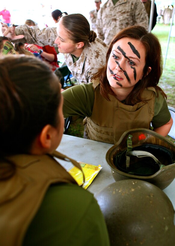 Cyndie Kapece applies camouflage face paint onto Rikki Ramsey, a Marine wife, during 2nd Radio Battalion’s Jane Wayne Day, aboard Marine Corps Base Camp Lejeune, N.C., May 19, 2012. Jane Wayne day is an annual event held by 2nd Radio Bn. to give spouses an opportunity to participate in activities such as firing weapons and Marine Corps Martial Arts. (U.S. Marine Corps photo by Cpl. Daniel A. Wulz)