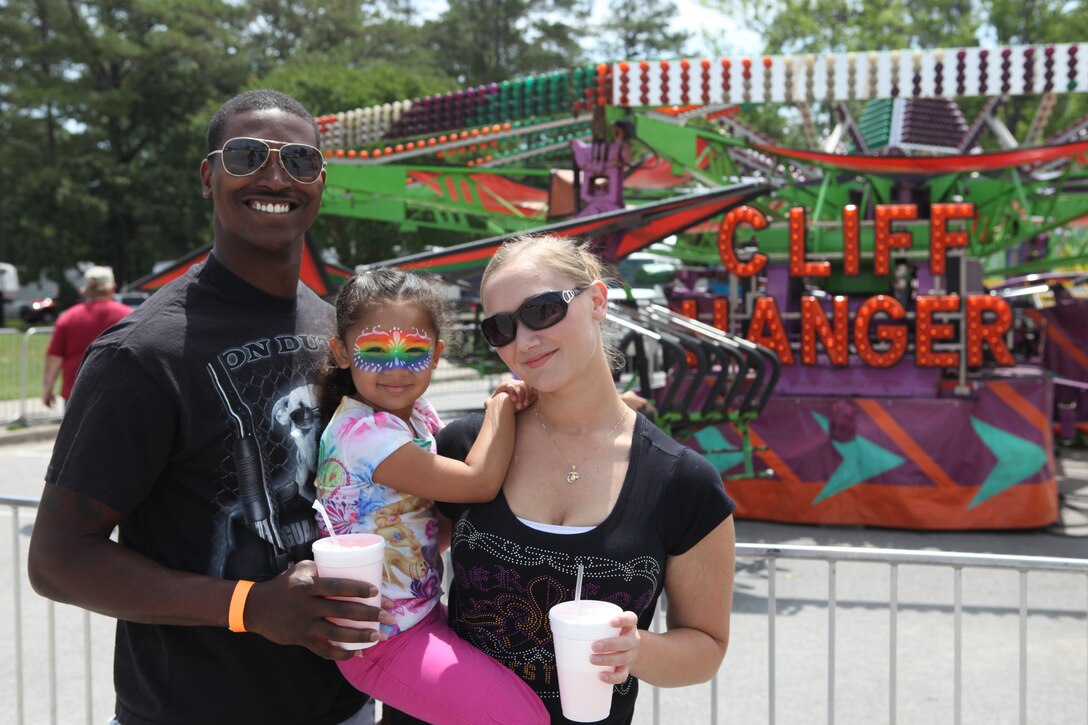 Cpl. Arnie Youngblood, with 2nd Light Armored Reconnaissance Battalion, poses for a photo with his family before their next carnival ride at Maynia abaord Marine Corps Base Camp Lejeune May 19.