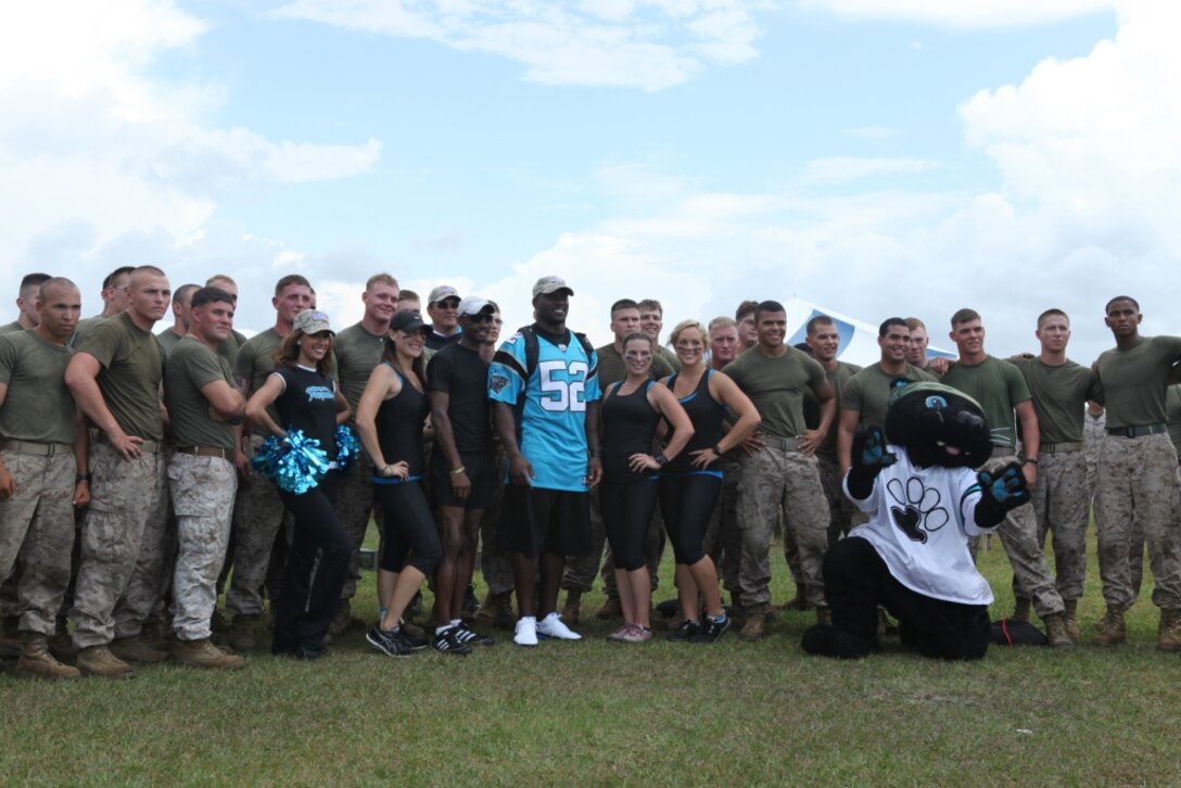 Members of the Carolina Panthers pose with Marines stationed aboard Marine Corps Base Camp Lejeune and a Semper Fit team after a combat conditioning course demonstration May 15.