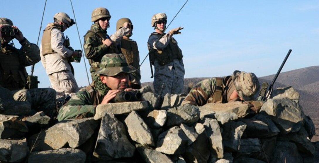 Gunnery Sgt. Shaun Leek (rear right), Capt. Devin Myler and Capt. Blaine Barby from Marine Corps Security Cooperation Group participated in a subject matter expert exchange with Marines from Second Marine Detachment “Miller” of the Republic of Chile’s Marine Corps (Cuerpo de Infanteria Marina de la Armada de Chile), at Puerto Aldea, Chile, May 14–18. Subject matter expert exchanges such as this one (fire support coordination ) are part of a long-term regional engagement plan by U.S Southern Command and U.S. Marine Corps Forces, South, towards increasing service partnerships and improving each country’s capabilities and interoperability.