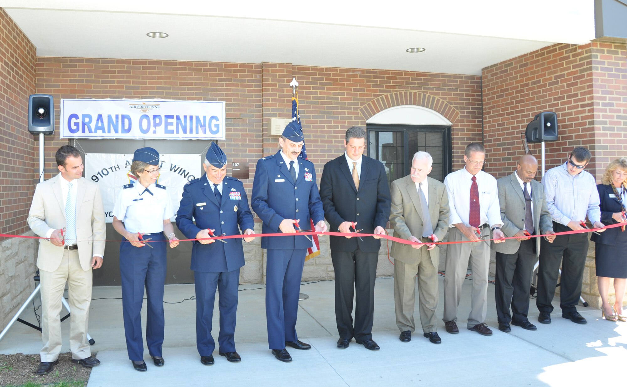 YOUNGSTOWN AIR RESERVE STATION, Ohio — The 910th Airlift Wing celebrated the grand opening of the second phase of the Eagle's Nest lodging here May 21.  A ceremonial ribbon cutting took place during the ceremony.  Cutting the ribbon for the nearly $10 million new lodging wing (left to right) are: Chris Halapy, project executive,Shook RJE Construction, Colonel Teresa Hams, commander of the 910th Mission Support Group, Colonel Nicholas Desport, AFRC Command Civil Engineer, Colonel Reinhard Schmidt, commander of the 910th Airlift Wing, Congressman Tim Ryan, 17th District Ohio, Jerry Cardinal, AFRC Services, Robert Woods, Youngstown ARS Chief of Civil Engineers, Kevin Jefferson, U.S. Army Corps of Engineers, Resident Engineer Brad Ryczko, U.S. Army Corps of Engineers, Project Manager and Cheryl Taylor, Youngstown ARS Lodging Manager.  U.S. Air Force photo by Staff Sgt. Megan Tomkins.

