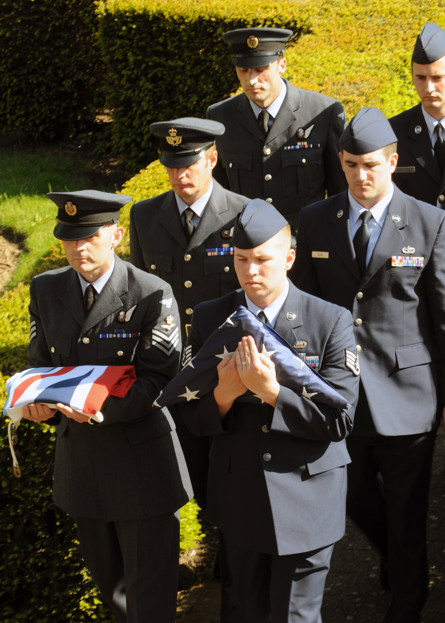 RAF MILDENHALL, England – Team Mildenhall Airmen from the 488th Intelligence Squadron and 95th Reconnaissance Squadron and British airmen from the 51 Squadron, Royal Air Force Waddington, secure the flag and march during a retreat ceremony here, May 25, 2012. Retreat signals the end of the duty day, while also paying respect to the flag. (U.S. Air Force photo/Master Sgt. Kevin Wallace)  