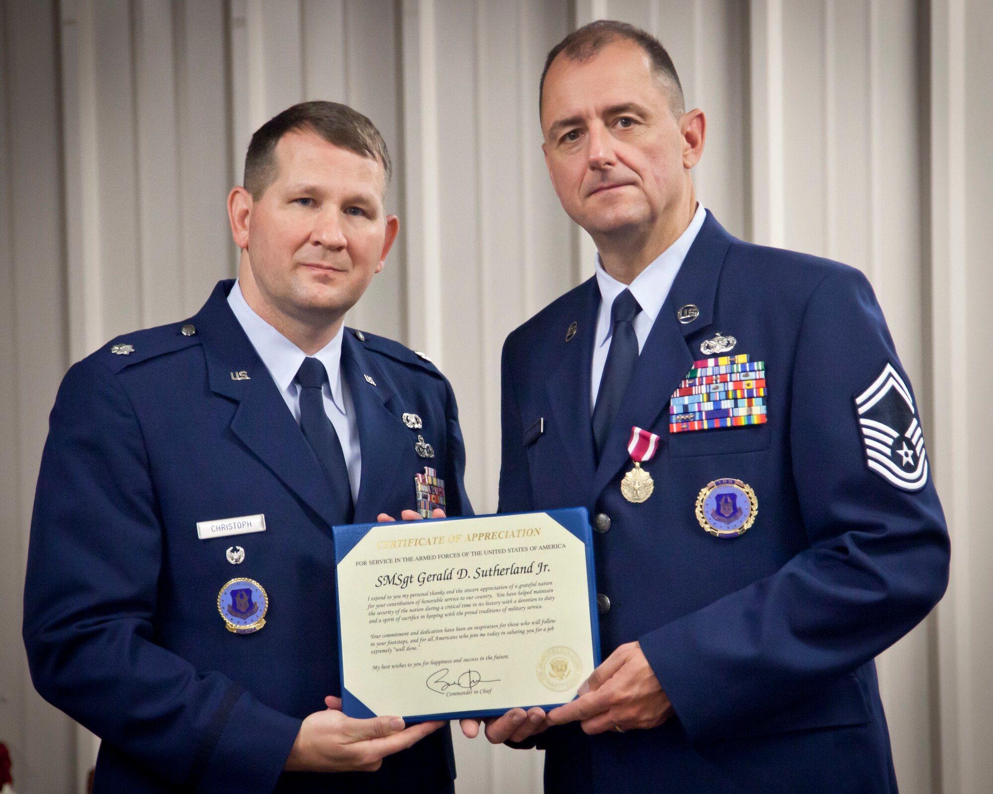 Lt. Col. Michael Christoph presents Senior Master Sgt. Gerald Sutherland with his Meritorious Service medal, Certificate of Retirement, and Certificate of Appreciation from the President.  Sergeant Sutherland retires after 27 years of military service, his last post being Senior Recruiter for the 934th Airlift Wing at Minneapolis-St. Paul Air Reserve Station, Minn.  (U.S. Air Force Photo/Shannon McKay)