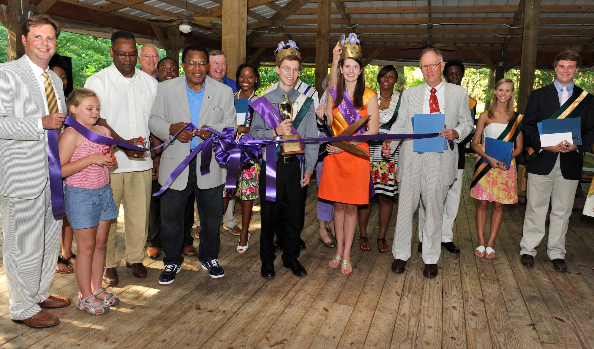 Local Sumter leaders and the court of the Iris Festival cut a ribbon during the official opening ceremony of the three day long Iris Festival at Swan Lake Iris Gardens, Sumter, S.C., May 24, 2012. The festival will feature numerous shows, performances and activities, and will be free to the general public. (U.S. Air Force photo by Senior Airman Amber E. N. Jacobs/Released)
