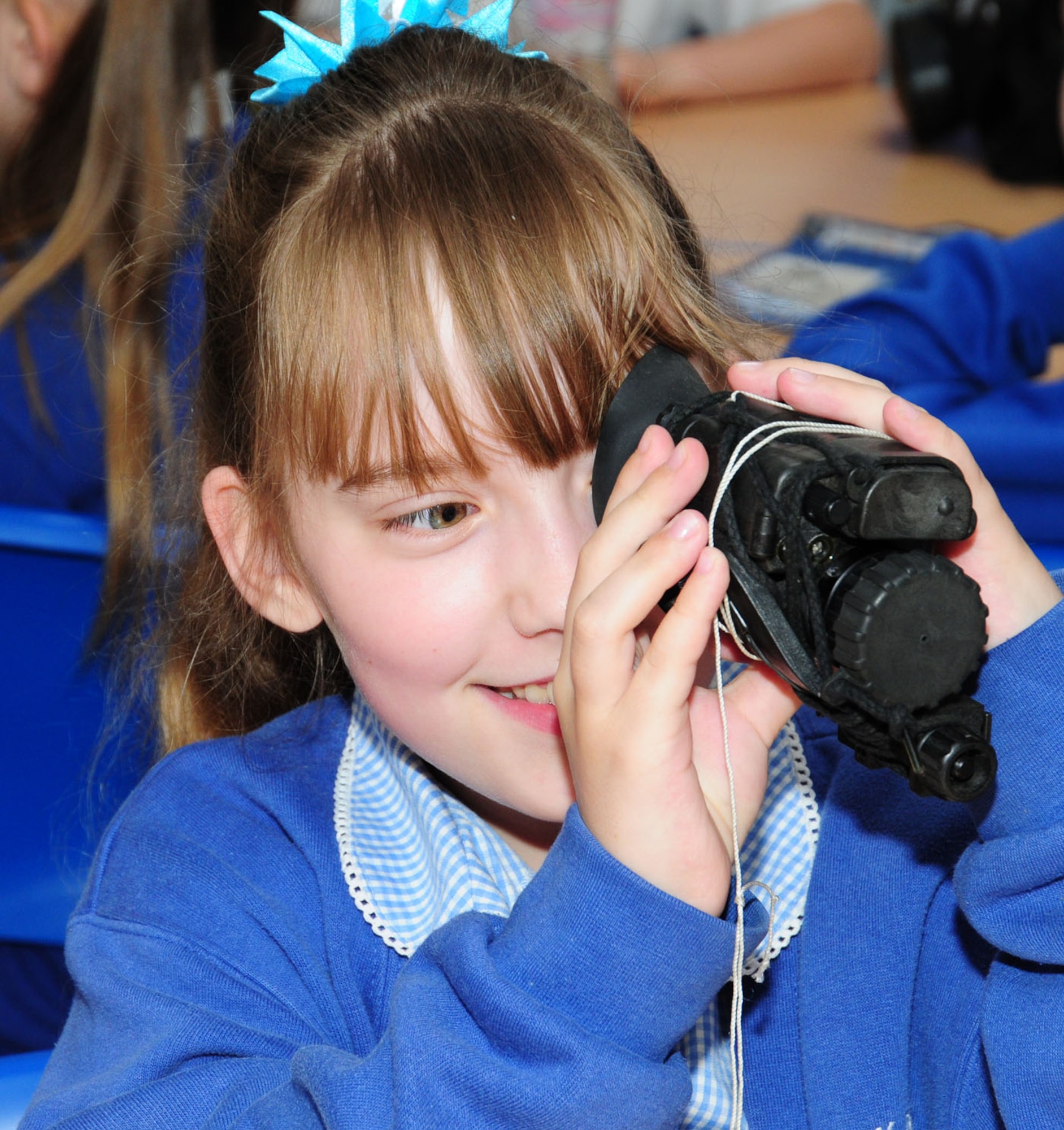 BECK ROW, England – Jasmine Dove, 10, looks through night-vision goggles May 25, 2012, at Beck Row Primary School, near RAF Mildenhall. Seven Airmen from the 100th Security Forces Squadron visited the local school children to demonstrate some of their equipment including a Kevlar helmet, night-vision goggles and bandages. (U.S. Air Force photo/Karen Abeyasekere)