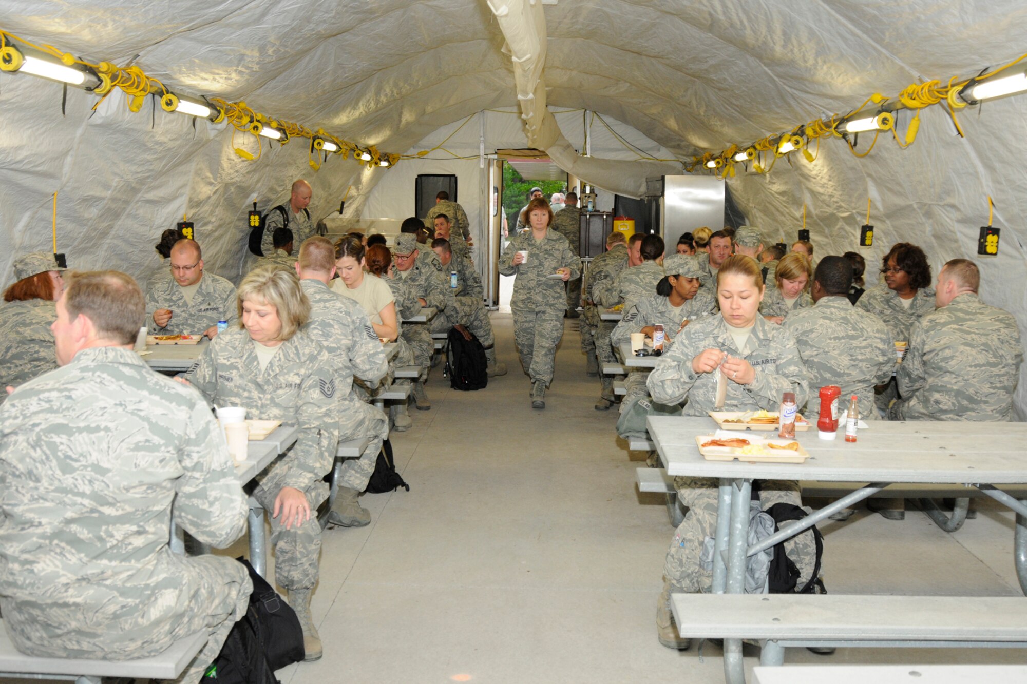 Airmen from Air National Guard medical groups from seven different states have breakfast during a a medical disaster response training exercise at the Alpena Combat Readiness Training Center in Alpena, Mich., May 25, 2012. The exercise brought together medical specialists from eight units in seven different states. (U.S. Air Force photo by TSgt. David Kujawa)