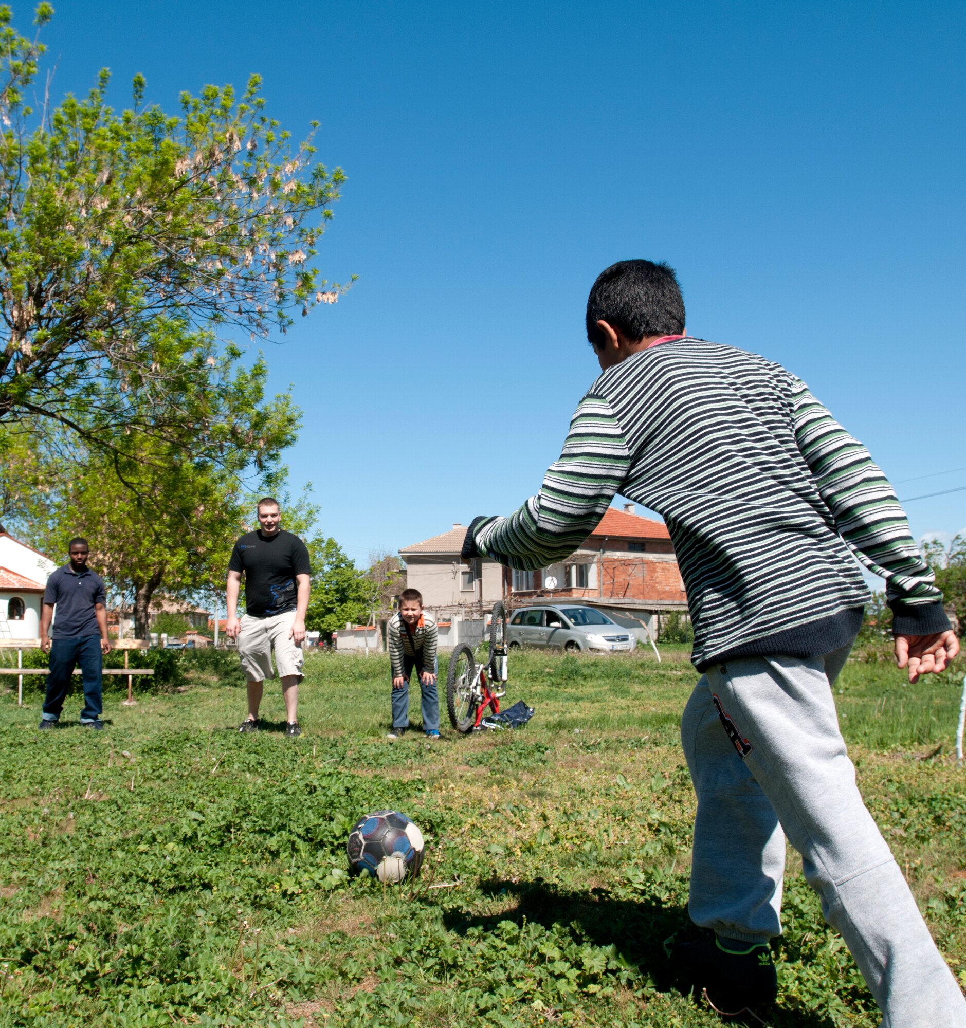 U.S. Air Force members play soccer with Bulgarian children April 22, 2012 in Graf Ignatievo, Bulgaria. More than 150 U.S. and Bulgarian Air Force members volunteered their off-duty time to refurbish playground equipment and build a soccer field at a village playground. Volunteers cleaned and painted playground equipment and raked, supplied new goals, cleaned and laid grass seed down in a field. (U.S. Air Force photo/Senior Airman Katherine Windish)
