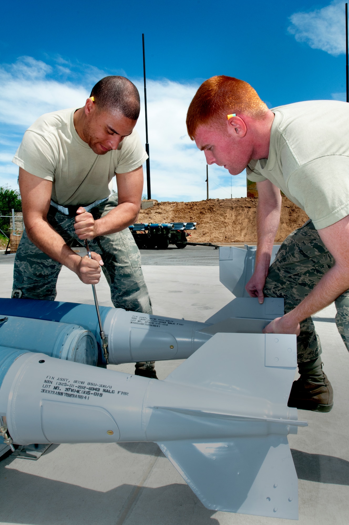 Airmen 1st Class Jarryd Burke and Joshua Gibbons, 31st Munitions Squadron conventional maintenance crew chief and storage crew member respectively, build a bomb May 19 at Graf Ignatievo Air Base, Bulgaria, in support of exercise Thracian Star 2012. The munitions, aircraft maintenance and maintenance operations squadrons worked jointly during the exercise, building and loading bombs and ammunition to be used for air-to-ground sorties, during which 536 bombs were dropped and 9,250 rounds of 20 millimeter ammunition were expelled at the local range. (U.S. Air Force photo/Senior Airman Katherine Windish)