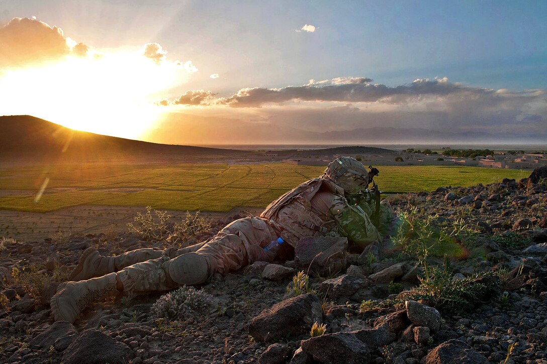 A U.S. Army paratrooper provides overwatch security to fellow paratroopers and Afghan soldiers after a firefight in Afghanistan's Ghazni province, May 17, 2012. The paratrooper is assigned to the 82nd Airborne Division’s 1st Brigade Combat Team. Insurgents use the agricultural areas surrounding Combat Outpost Giro for various activities.