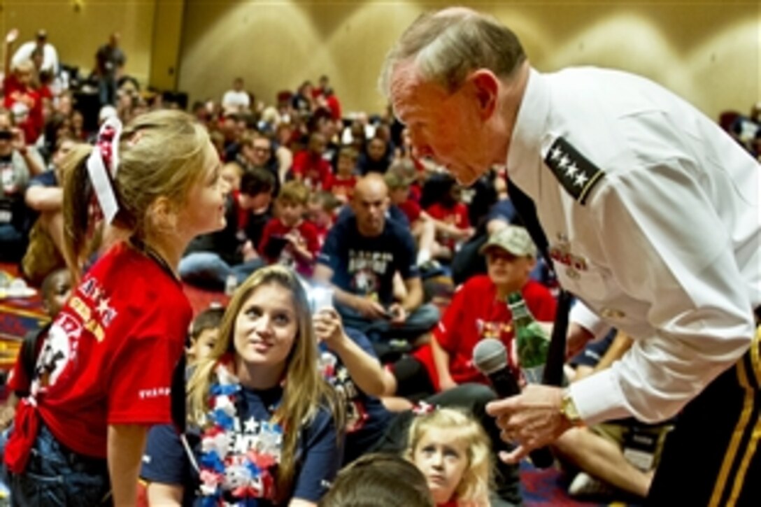 Army Gen. Martin E. Dempsey, chairman of the Joint Chiefs of Staff, talks with a child with the TAPS organization at the 18th annual TAPS National Military Survivor Seminar and Good Grief Camp in Arlington, Va., May 25, 2012. TAPS, or Tragedy Assistance Program for Survivors, is a nonprofit group that supports surviving families of fallen service members.