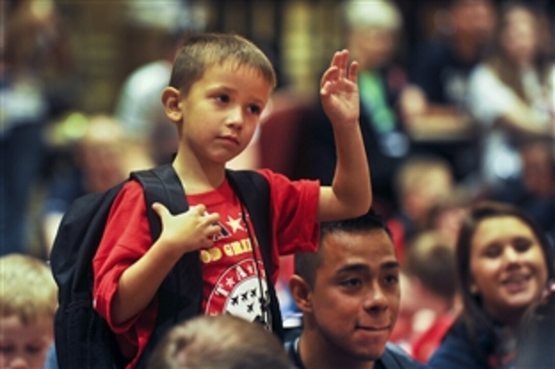 A child with the TAPS organization raises his hand to ask a question of Army Gen. Martin E. Dempsey, chairman of the Joint Chiefs of Staff, at the 18th annual TAPS National Military Survivor Seminar and Good Grief Camp in Arlington, Va., May 25, 2012. TAPS, or Tragedy Assistance Program for Survivors, is a nonprofit group that supports surviving families of fallen service members.