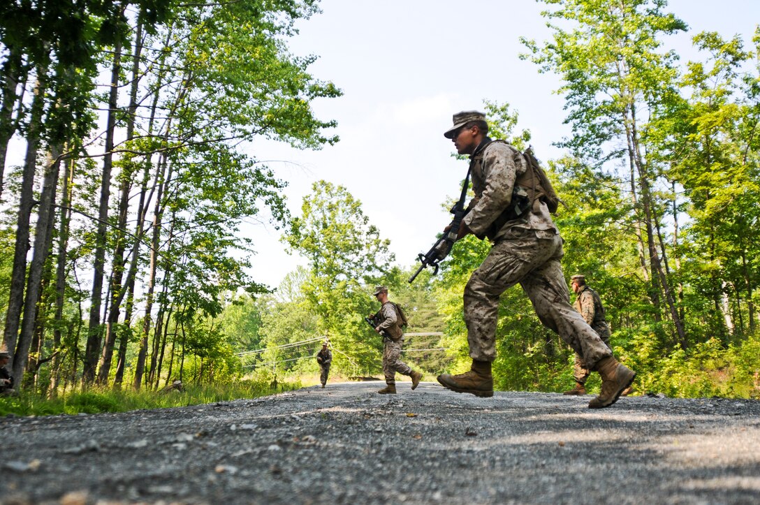 Second Lt. Jerry Hauburger, a rifleman with 2nd Platoon, 4th Squad, Charlie Company, The Basic School, sprints across a road during a foot patrol exercise at Landing Zone 7, May 25. More than 200 Marines with Charlie Co.,TBS, completed their final preparations for their convoy exercise.