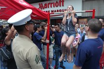 Jenna Holcomb, a student at Mcauliffe Middleschool, performs a flexed-arm-hang during Marine Day in Times Square, May 26. Marine Day is part of Fleet Week New York 2012, where Marines and sailors show New Yorkers Marine Corps weapons, equipment and culture.