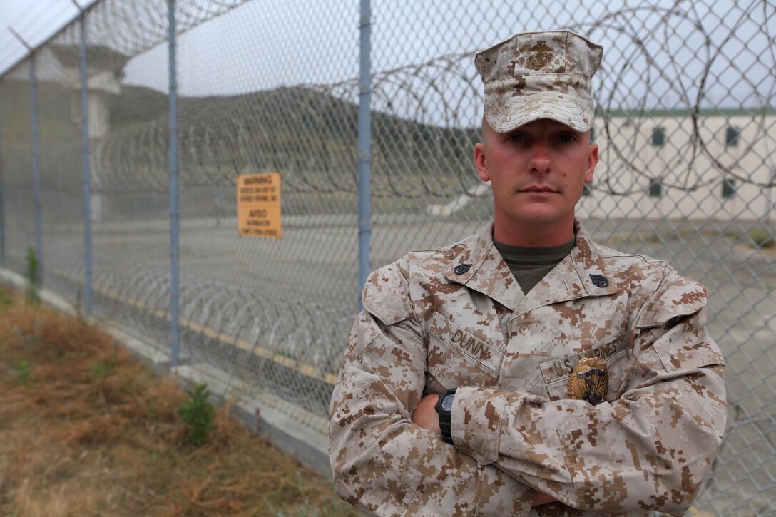 Staff Sgt. Ryan S. Dunn, a corrections specialist with Security Battalion, Marine Corps Base Camp Pendleton, stands in front of the base brig perimeter gate. The American Correctional Association and the Military Corrections Committee will be presenting Dunn with the 2012 Marine Corps Best of the Best Corrections Specialist of the Year Award at the ACA 2012 Summer Conference in Denver, Colorado, July 20-25.