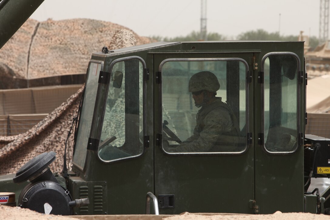 Lance Cpl. Othello Taylor, heavy equipment operator, Alpha Company, Combat Logistics Battalion 5, 1st Marine Logistics Group (Forward), operates a Kalmar during a combat logistics patrol to Forward Operating Base Hanson, May 25. During the patrol, Marines dropped off items for resupply and retrieved items from the base to retrograde back to Camp Dwyer.