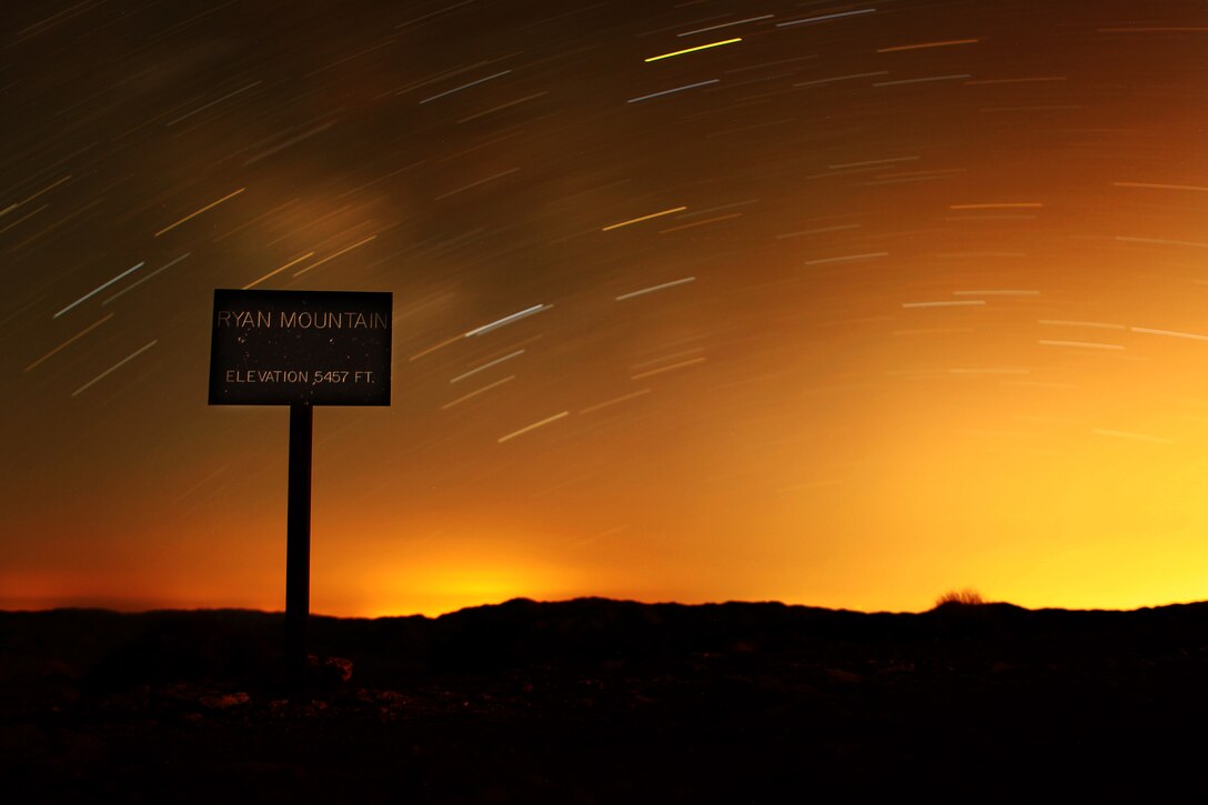 This photo is the bane of my existence. This wasn't planned and even if it was, I'd have no idea what to do. The original idea for where this photo was shot was to shoot the city lights from Ryan Mountain, an almost two-mile hike to a peak of 5,457. The night started with a random walk to a cluster of rocks that me and GySgt. Leo Salinas saw. There was no real reason we started walking other that pure dread of walking up Ryan Mountain, so we stalled, hoping the other would call the plan off. Reluctantly, we found ourselves crawling through bushes, climbing up rock faces with our fair share of camera gear bogging us down and our efforts of hoping the other would call it off never came. Almost an hour later we arrived with a few unusable pictures of the city lights. I set my camera down laid on the cold mountain and stared at the sign. It hit me. "I wanna take this photo," I said. I explained the shot. "Do you know how to do that?," was the first thing he asked me. I didn't and I still don't. Four hours and 30 pictures later, I believed it was straight luck to even get a picture in focus.