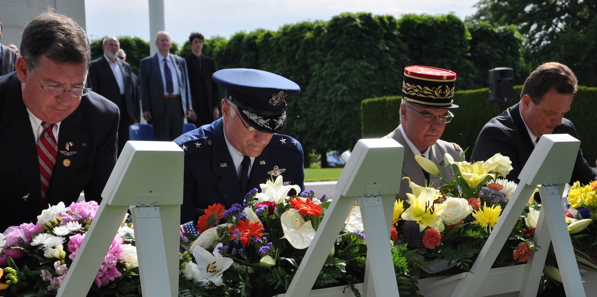 THIAUCOURT, France -- Even G. Reade, U.S. General Consul - Strasbourg, France; Maj. Gen. David J. Scott, U.S. Air Forces in Europe vice commander, and other distinguished guests pause for a moment of silence after placing wreaths during the annual the Memorial Day event at the St. Mihiel American Cemetery May 27, 2012. U.S. Air Forces in Europe Airmen and other locals participated in the annual Memorial Day Ceremony at the 40.5-acre World War I cemetery, about 24 miles southwest of Metz, France. The cemetery contains the graves of 4,153 of U.S. military dead. It is the third largest of the eight World War I American military cemetery memorials in Europe. (U.S. Air Force photo by Tech. Sgt. Francesca Popp)