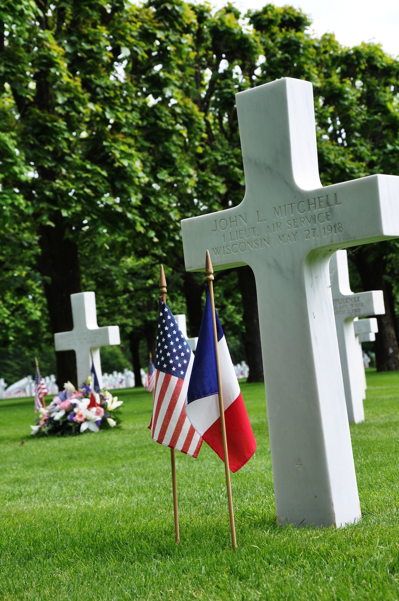 Thiaucourt, France -- 1st Lt. John L. Mitchell, brother of Brig. Gen. William "Billy" Mitchell, is one of 4,153 service members buried at the World War I St. Mihiel American Cemetery and Memorial. His final resting place lays in Plot D, Row 1, Grave 4 of the 40.5-acre cemetery. U.S. Air Forces in Europe Airmen and other locals honored Mitchell and other U.S. service members during the annual Memorial Day ceremony May 27, 2012 at the World War I cemetery about 24 miles southwest of Metz, France. The cemetery is open 9 a.m. to 5 p.m. daily, except Dec. 25 and Jan. 1. For more information, visit www.abmc.gov/cemeteries/cemeteries/sm.php. (U.S. Air Force photo by Tech. Sgt. Francesca Popp)