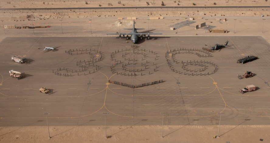 A Minnesota Air National Guard C-130 “Hercules” and several Minnesota Airmen are featured in a photo of the 386th Air Expeditionary Wing on May 26, 2012, taken at an undisclosed location in Southwest Asia. The 133rd Airlift Wing has over 150 Airmen deployed around the world from all groups from the base at the Minneapolis – St. Paul international airport.