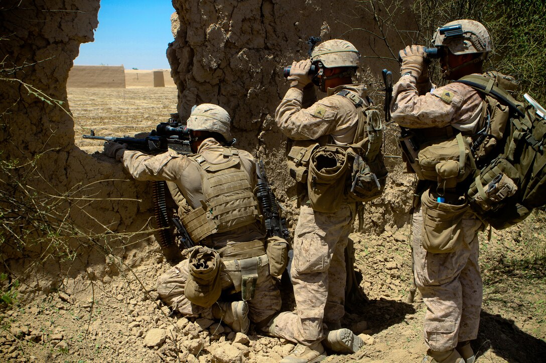 Three Marines with 2nd Battalion, 5th Marine Regiment, stack up behind each other to view a suspicious compound during a patrol, May 27, 2012. The Marines cleared Zamindawar, disrupting the insurgents leadership and logistics chain.