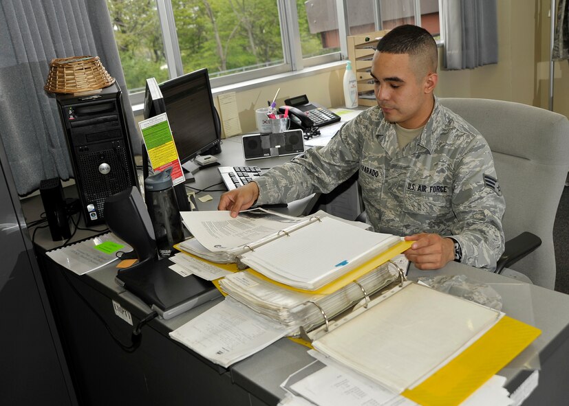 U.S. Air Force Senior Airman Bryan Alvarado, 35th Logistics Readiness Squadron Vehicle Management Flight hazardous waste manager, inspects his records at Misawa Air Base, Japan, May 23, 2012. Alvarado oversees the approval, use and disposal of all chemicals used to maintain more than a 1000 government owned vehicles. (U.S. Air Force photo by Staff Sgt. Nathan Lipscomb/Released)