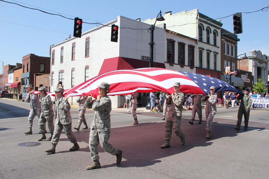 A gust of air blows the flag higher in the main street march.  Airmen of the 932nd Airlift Wing marched the American flag in the 2012 Belleville, Ill, annual Memorial Day Parade. While the weather was warm, so were the hearts of fellow Americans who came out to thank veterans and those who have lost their lives in service to their country.  Volunteers for this year's parade were given several standing ovations throughout the trip down main street in Illinois. (U.S. Air Force photo/Maj. Stan Paregien, 932nd AW Public Affairs)