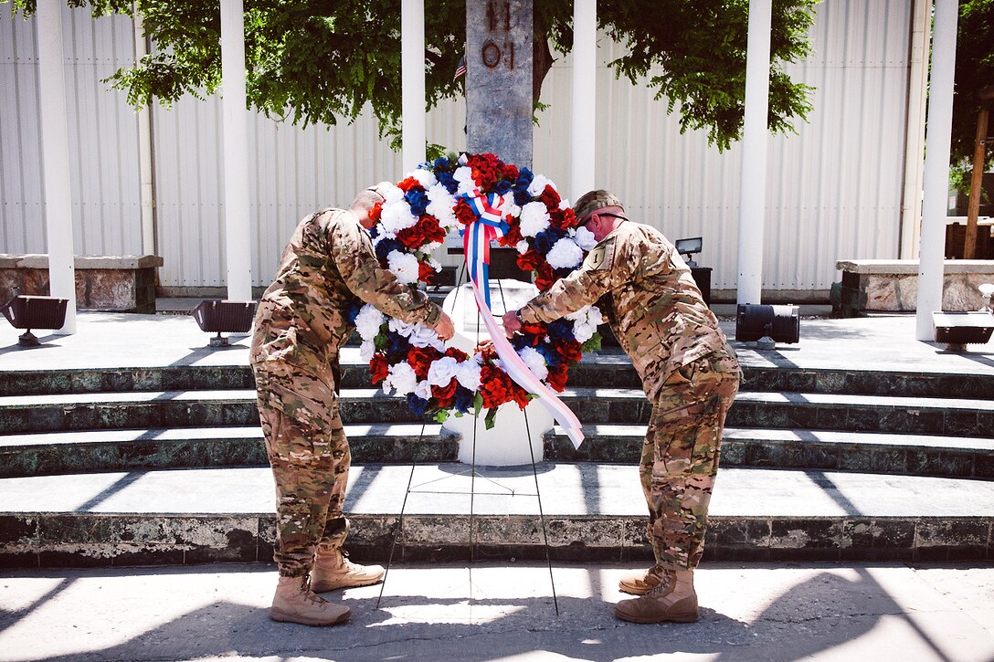 U.S. Army Maj. Gen. William C. Mayville Jr., left, and U.S. Army Command Sgt. Maj. Charles V. Sasser Jr., right, lay a wreath in honor of fallen U.S. service members during a Memorial Day ceremony on Bagram Air Field, Afghanistan, May 28, 2012. 