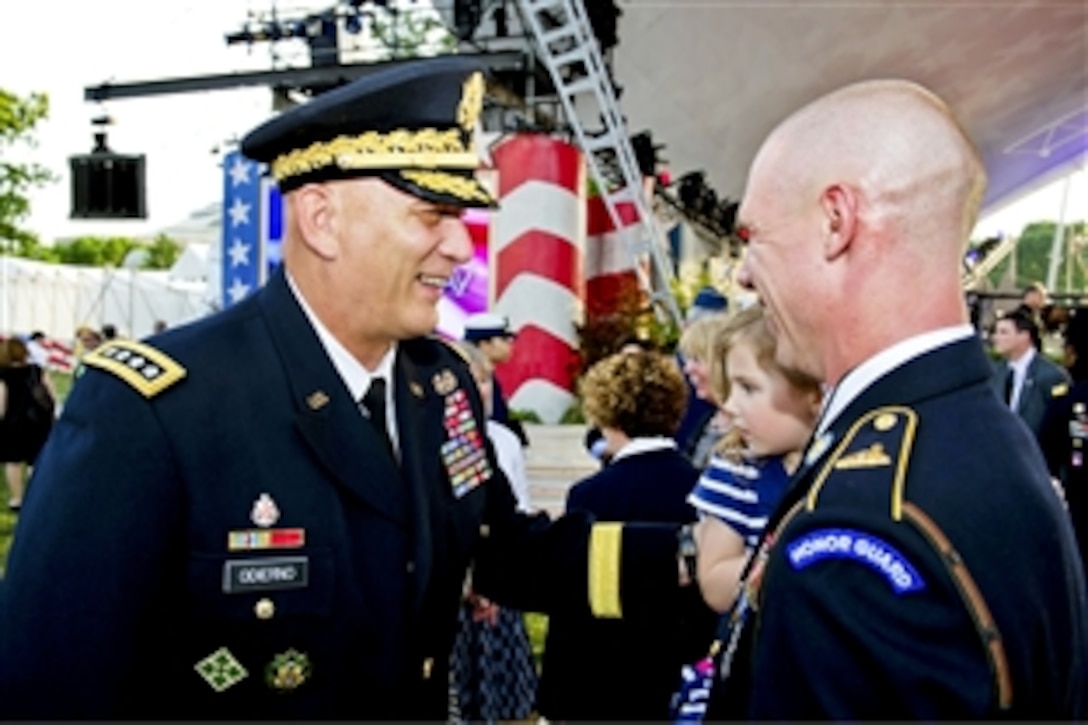 Army Chief of Staff Gen. Ray Odierno smiles with Army Staff Sgt. Rittersdorf and his daughter during the National Memorial Day concert at the National Mall in Washington, D.C., May 27, 2012.