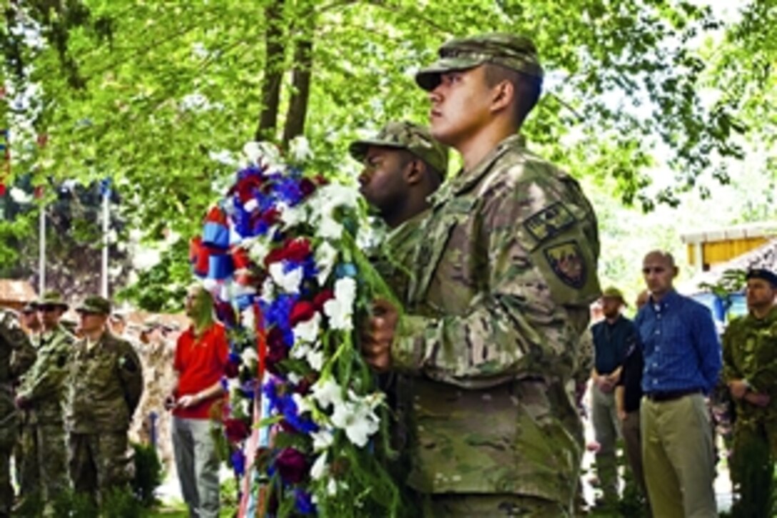 U.S. service members prepare to present a wreath during a Memorial Day ceremony at the International Security Assistance Force headquarters in Kabul, Afghanistan, May 28, 2012.