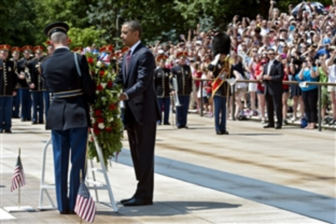 President Barack Obama lays a wreath at the Tomb of the Unknown Soldier during the Memorial Day observance ceremony at Arlington National Cemetery in Arlington Va., May 28, 2012. Obama urged all Americans to remember those who have sacrificed for the nation and to support the surviving family members of fallen service members.