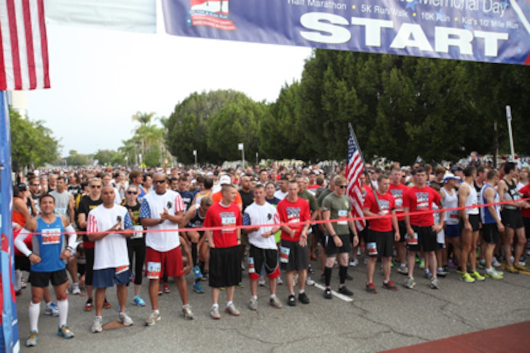 Marines from Battalion Landing Team, 3rd Battalion, 5th Marines, 15th Marine Expeditionary Unit, Camp Pendleton, Calif., wait as lead runners in the Laguna Hills Memorial Day Half Marathon in Laguna Hills, Calif., May 28.  More than 100 Marines from the battalion ran in the race in honor of their Marine brothers who lost their lives in battle.  The city of Laguna Hills adopted the battalion in 2007 and has supported it both at home and while deployed.