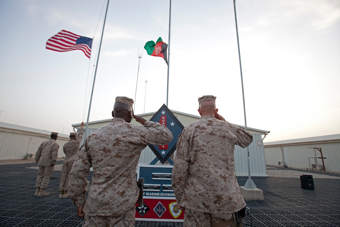 U.S. Marine Corps Maj. Gen. David H. Berger, right, commanding general of Task Force Leatherneck (TFL) and Sgt. Maj. Terry L. Jones, TFL Sergeant Major, salute the American Flag during an evening colors ceremony on Camp Leatherneck, Helmand province Afghanistan May 28, 2012. Berger held the ceremony as a Memorial Day Commemoration in remembrance for those who have died in our nation's service. (U.S. Marine Corps Photo by Sgt. Sheila M. Brooks)::r::::n::::r::::n::::r::::n::