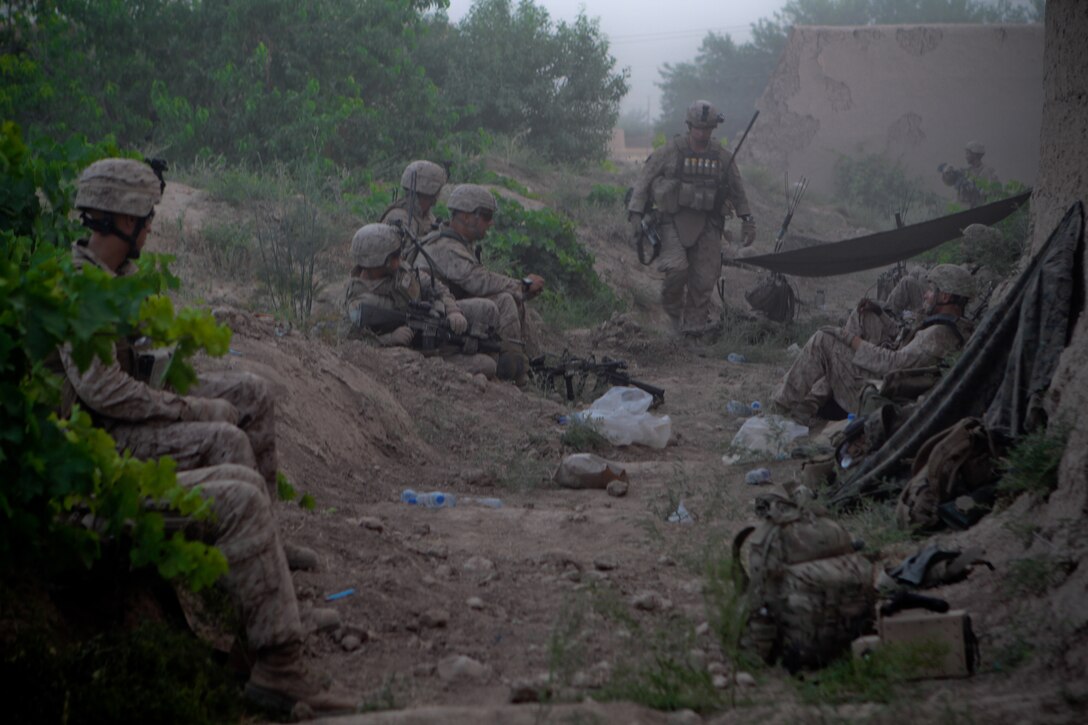 Marines with 2nd Battalion, 5th Marine Regiment, take a breather as the smoke clears from a firefight, May 28, 2012. The Marines encountered small arms fire, mortars and rocket-propelled grenades, during their clearing operation through Zamindawar.