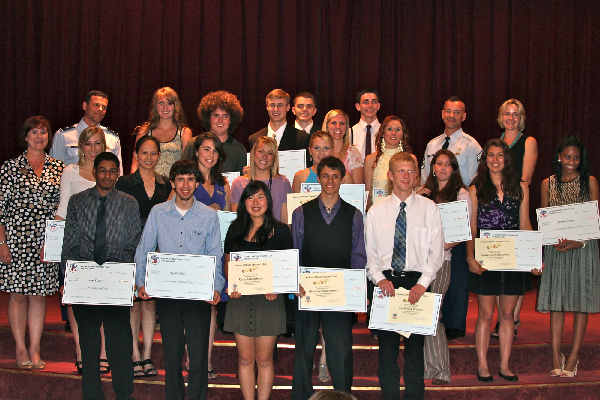 The Kadena Officers' Spouses' Club awarded 21 scholarships for a combined total of $24,000 to military family members during a ceremony at Kadena Air Base, Japan, May 17. In the past two years, the Kadena Officers' Spouses' Club has awarded $55,000 in scholarships to help students pay for tuition and books. (Air Force courtesy photo)