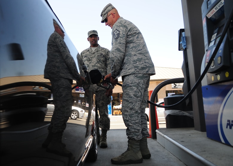 Master Sgt. Chad Hepner, 9th Medical Group first sergeant, buys fuel for Airman 1st Class Ireton Bennett, 9th Communications Squadron, as a random act of kindness May 24, 2012 at the housing shoppette, Beale Air Force Base, Calif. Beale’s first sergeants purchased $2,000 in fuel for Airmen E-1 through E-5 and washed windshield during the Operation Warm Heart event. (U.S. Air Force photo by Senior Airman Shawn Nickel)