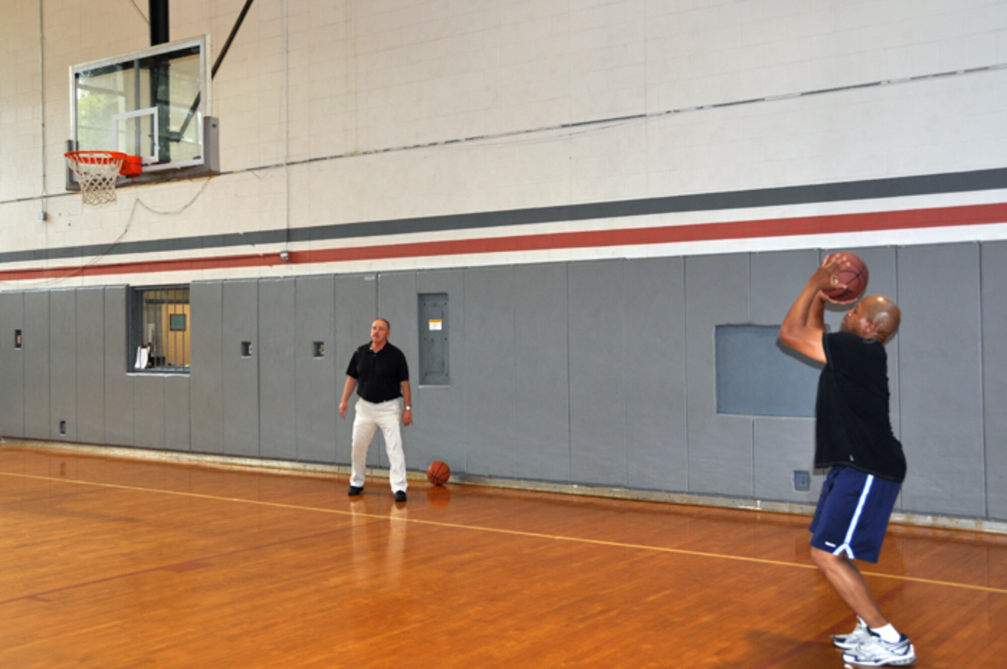Tech Sgt. Rodney A. Cox, of the 94th Airlift Wing Civil Engineering Squadron, takes a shot at the Dobbins ARB three-point contest on May 17. Fred Ingle, fitness center staff member, acted as the referee. The contest was coordinated by the Dobbins ARB fitness center as part of May Fitness Month. (U.S. Air Force photo/Senior Airman Elizabeth Gaston)