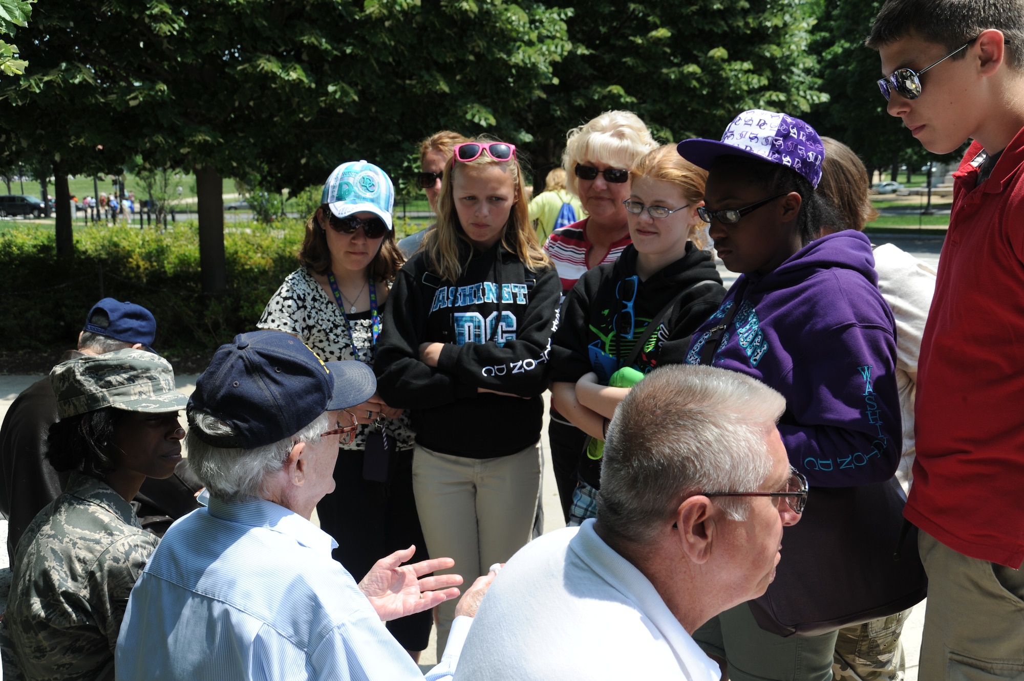 A group of students stop to converse with Bill Brentland during a field trip to the World War II Memorial in Washington, D.C., May 17. Brentland is a retired WWII veteran who experienced the bombing of Pearl Harbor first-hand. (U.S. Air Force photo/Airman 1st Class Aaron Stout)