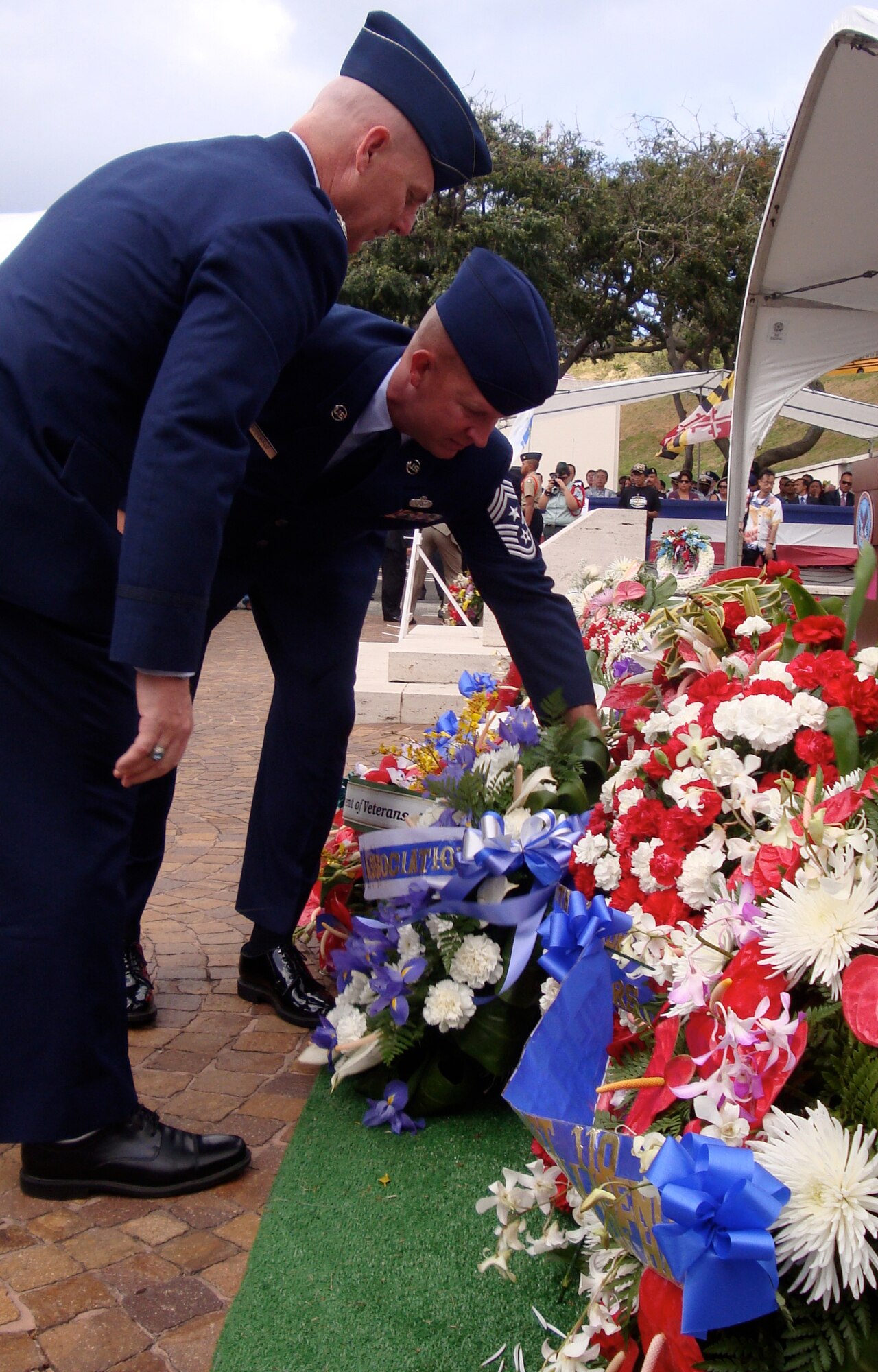 Col. Sam Barrett, 15th Wing commander, and Chief Master Sgt. Robert Rodewald, 15th Wing command chief, place flowers May 28 during a Memorial Day ceremony at the National Memorial Cemetery of the Pacific in Honolulu, Hawaii. 