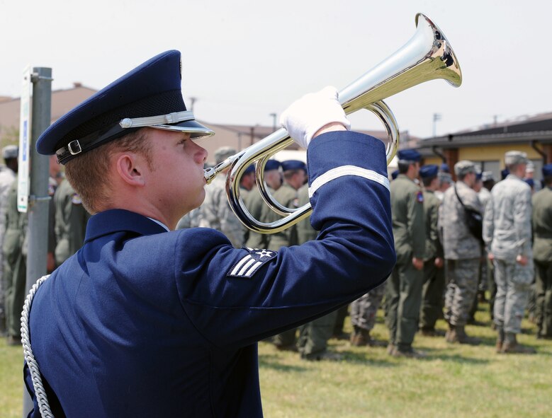A Dyess Honor Guardsman plays the trumpet during a 317th Airlift Group Memorial Day ceremony May 24, 2012, at Dyess Air Force Base, Texas. Memorial Day is a day of remembering the men and women who died while serving in the United States Armed Forces. Formerly known as Decoration Day, it originated after the American Civil War to commemorate the Union soldiers who died in the Civil War. By the 20th century Memorial Day had been extended to honor all Americans who have died in all wars. (U.S. Air Force photo by Airman 1st Class Charles V. Rivezzo/ Released)