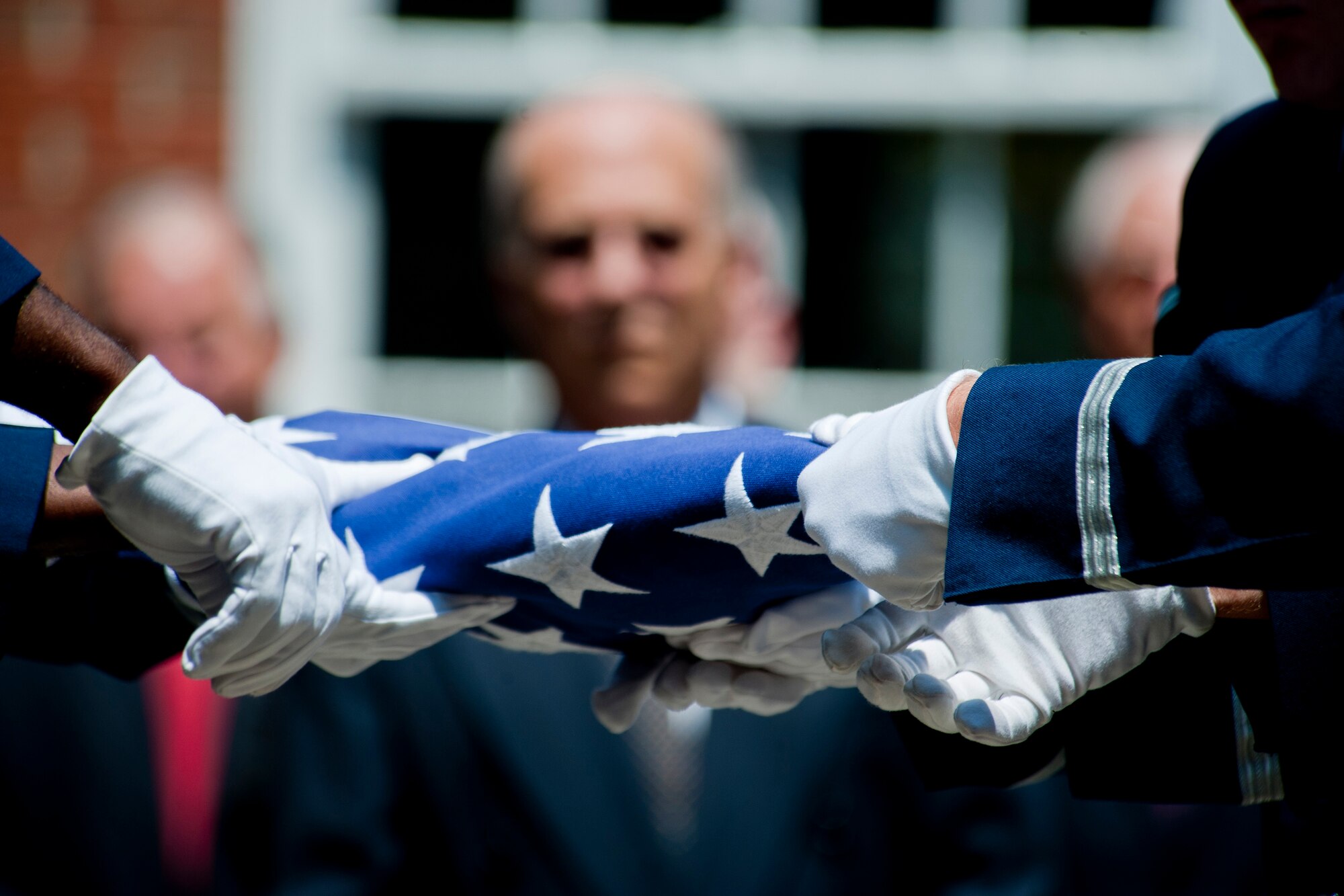 Members of the Moody Air Force Base Honor Guard perform a flag-folding tribute during a memorial service for retired U.S. Air Force Lt. Col. Donald Bryan May 26, 2012, at Christ Episcopal Church in Valdosta, Ga. The service also contained a gun salute and a missing man formation with A-10C Thunderbolt II aircraft. (U.S. Air Force photo by Staff Sgt. Jamal D. Sutter/Released) 