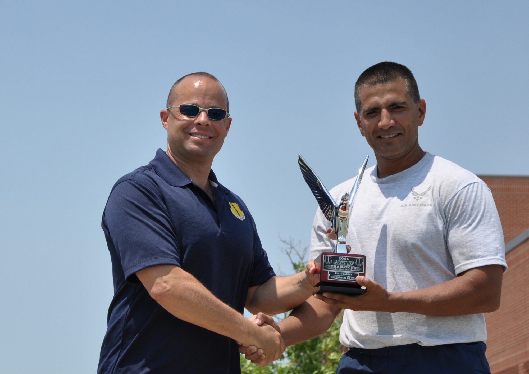 GOODFELLOW AIR FORCE BASE, Texas— Col. Mark Damiano, 17th Training Wing Commander presents Lt. Col. Michael Jones, Mission Support Group Commander, with the Large Unit award during Sports and Safety Day, May 24. The quarterly event is meant to boost morale and increase safety awareness. (U.S. Air Force photo/Airman 1st Class Jessica Keith)