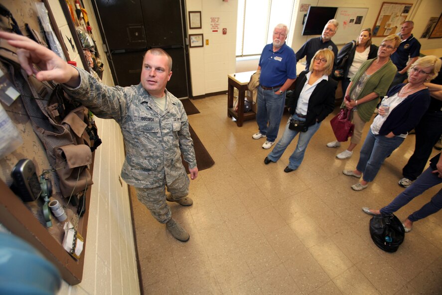 Non-commissioned officer in charge of Life Support Senior Master Sgt.Jason L. Gioconda, left, describes the functions of various pieces of survival gear to employers of 177th Fighter Wing Guardsmen May 23, 2012.  The New Jersey Committee for Employer Support of the Guard and Reserve (ESGR) and the 177th Fighter Wing, New Jersey Air National Guard, held a 177th Employer Appreciation Day where traditional Guardsmen brought their employers to the Wing. After a briefing about the Wing's mission by Wing commander Col. Kerry M. Gentry, the employers toured the base, witnessed a ground scramble of F-16 Fighting Falcons and flew in a UH-60 Black Hawk helicopter assigned to the 1-150th Assault Helicopter Battalion, New Jersey Army National Guard.  After the employers returned, they signed ESGR Statements of Support, which enlists the support of employers in the development of policies and practices that support and encourage employee participation in the Guard and Reserve. U.S. Air Force photo by Master Sgt. Mark C. Olsen