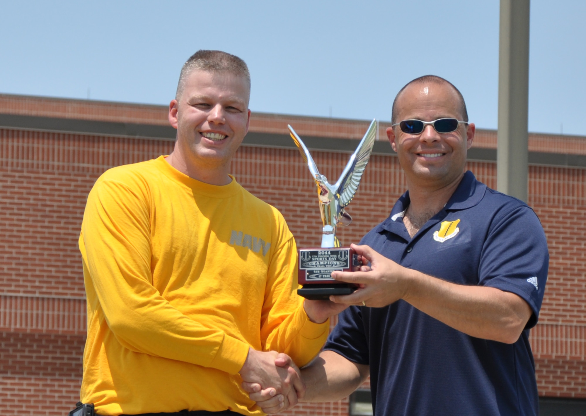 GOODFELLOW AIR FORCE BASE, Texas— Col. Mark Damiano, 17th Training Wing Commander presents Navy Lt. Commander Lonnie Griffith, Navy Center for Information Dominance Detachment Officer in Charge, with the Small Unit award during Sports and Safety Day, May 24. The quarterly event is meant to boost morale and increase safety awareness. (U.S. Air Force photo/Airman 1st Class Jessica Keith)