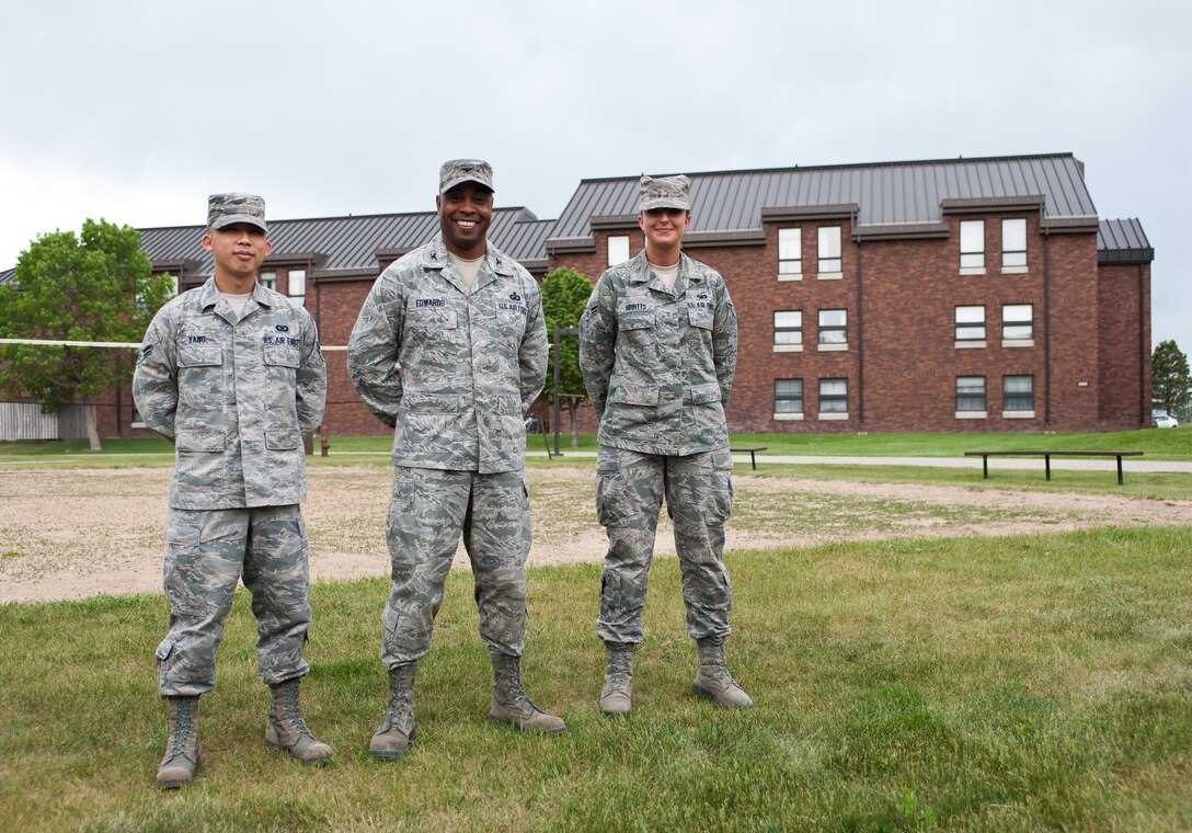Col. Trent Edwards, 28th Mission Support Group commander (center), Airman 1st Class Jonathan Yang (left), Dormitory Council vice president, and Airman 1st Class Leslie Hibbitts (right), Ellsworth Dormitory Council president, stand in front of the dorms at Ellsworth Air Force Base, S.D., May 17, 2012. The 28th MSG recently received and approved a request for the dorm council to make improvements such as new televisions, storage units, and sports equipment to improve the quality of life for dorm residents. (U.S. Air Force photo by Airman 1st Class Alystria Maurer/Released)
