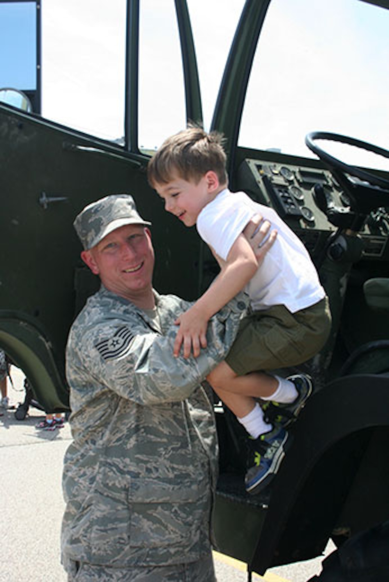 PITTSBURGH IAP ARS -- Tech. Sgt. Allen McCaw, of the 32nd Aerial Port Squadron, helps a young boy down from a military deuce and a half provided by the 911th Airlift Wing during the 5th Annual Touch-A-Truck event in Downtown Pittsburgh, May 19, 2012. The 911th works with the Junior League of Pittsburgh to provide Airmen volunteers as well as a military vehicle for Touch-A-Truck. This event gives fellow citizens and community members a chance to see a military truck up close and personal. (U.S. Air Force photo by Tech. Sgt. John Hapgood/Released by Airman 1st Class Justyne Obeldobel)