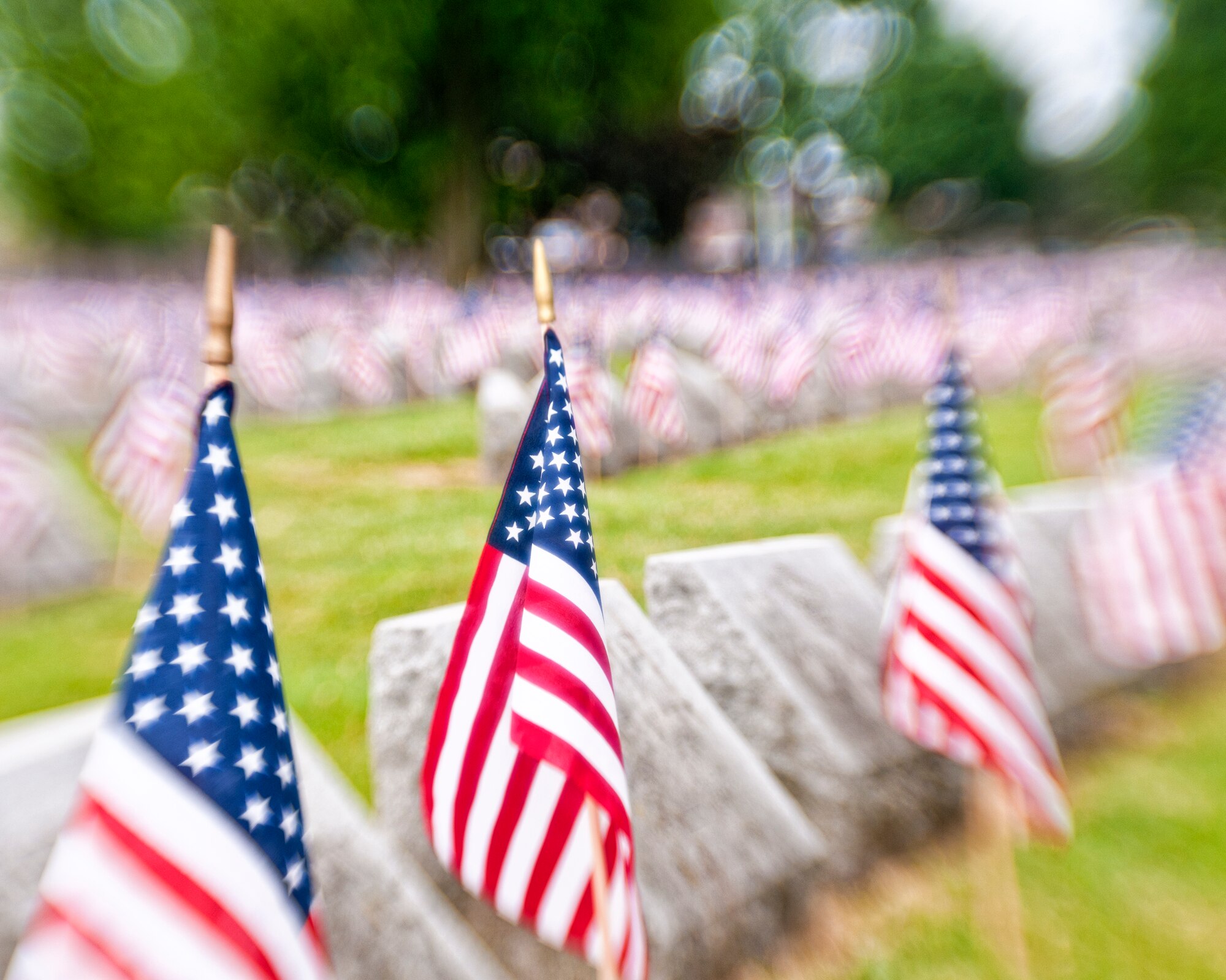 Volunteers place American flags on veteran’s graves during a Memorial Day ceremony held at Forest Lawn Cemetery, May 28, 2012, Buffalo, NY. During the morning thousands of flags where placed next to those men and woman who served in the United States military. (U.S. Air Force photo by Tech. Sgt. Joseph McKee