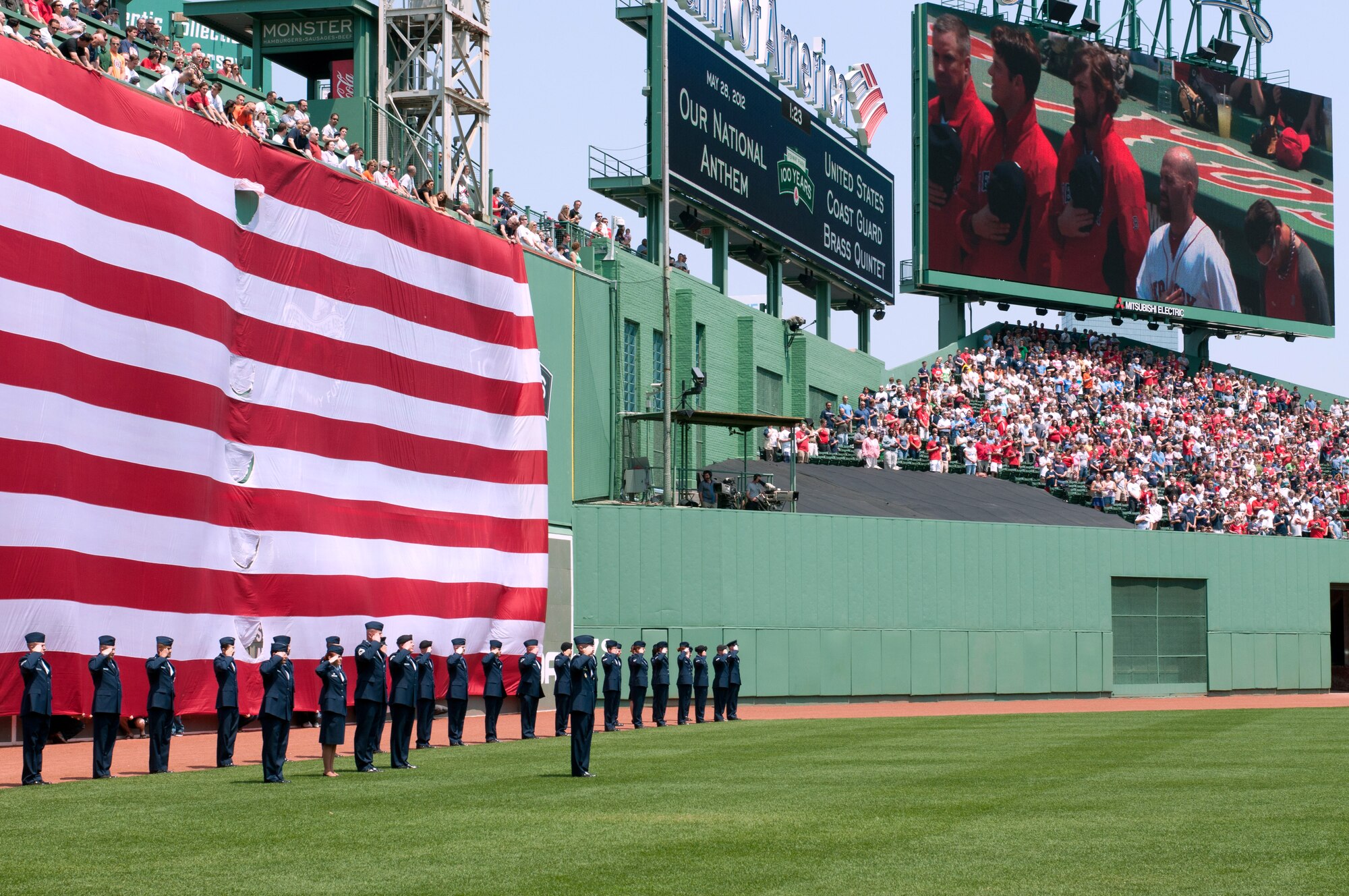HANSCOM AIR FORCE BASE, Mass. – Led by Col. Lester A. Weilacher, 66th Air Base Group commander, Airmen from Hanscom AFB render honors in a pre-game ceremony along the Green Monster at Fenway Park May 28. Members participated in the on-field ceremony commemorating Memorial Day. (U.S. Air Force photo by Rick Berry)